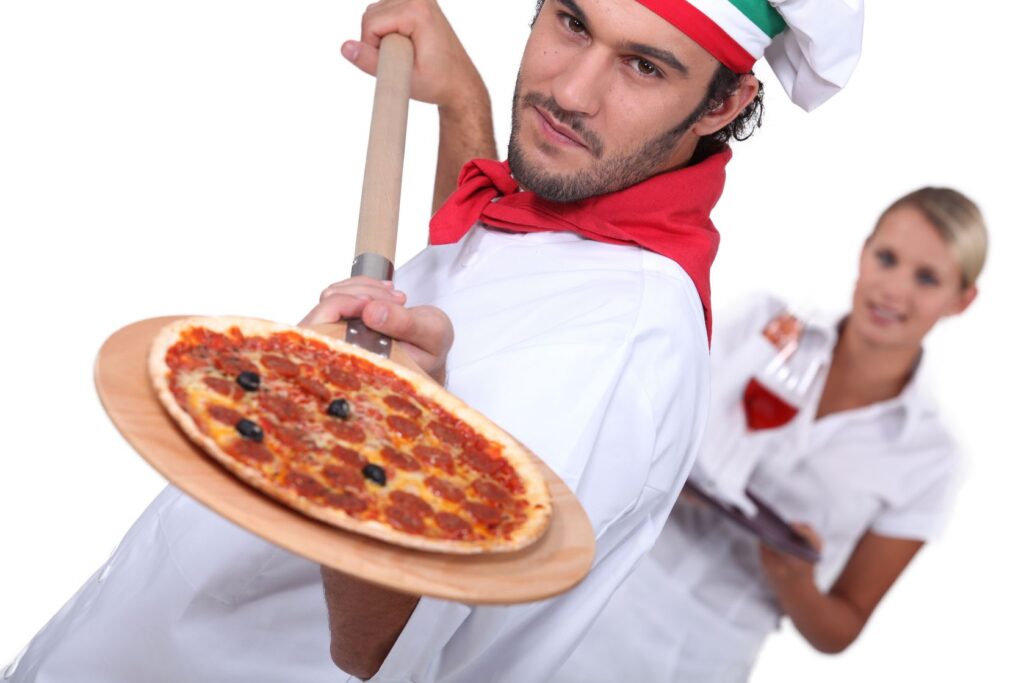 Immagine di una pizzeria moderna con forno a legna, tavoli apparecchiati e ambiente accogliente, ideale per avviare un'attività di ristorazione in Italia.